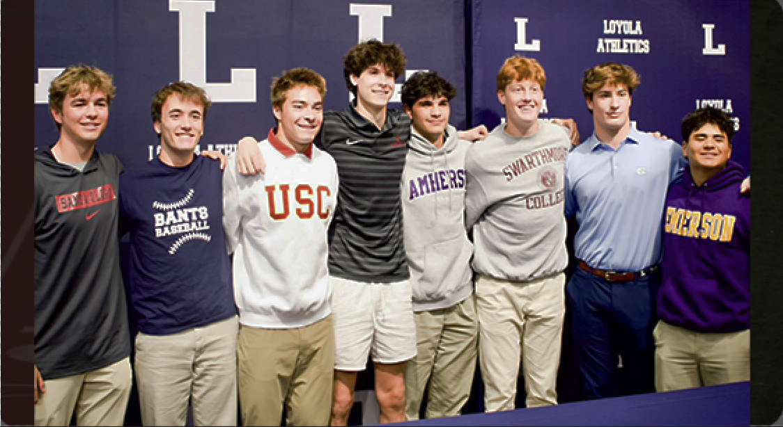 LOYOLA SENIORS SIGN with smiles.